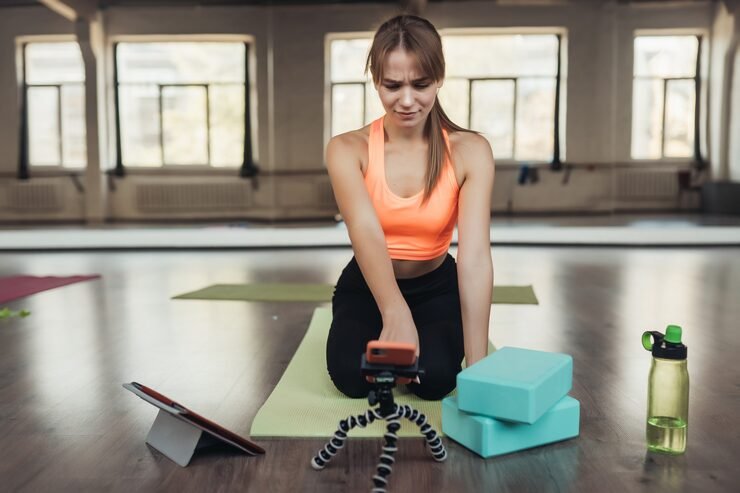 beautiful young woman practicing yoga is engaged with teacher online via tablet home sports concept 1153 8326