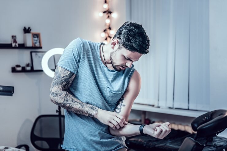 freshly made tattoo bearded young man blue t shirt looking text stuffed his skin with tattoo machine ink 259150 37735 1